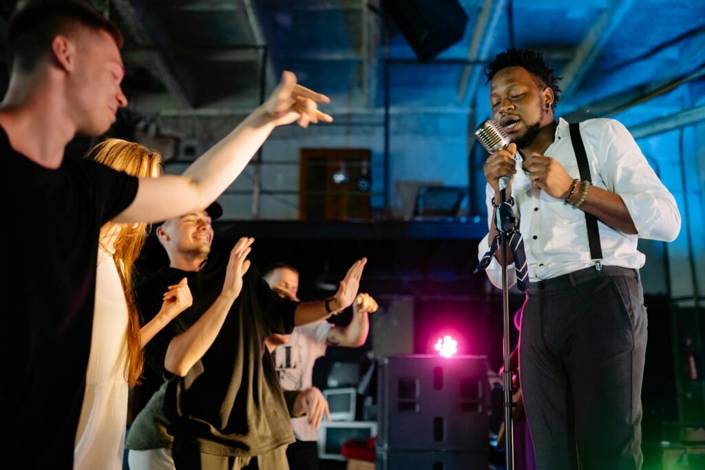 Dynamic scene of a live band performance with an engaged young crowd in a warehouse setting.